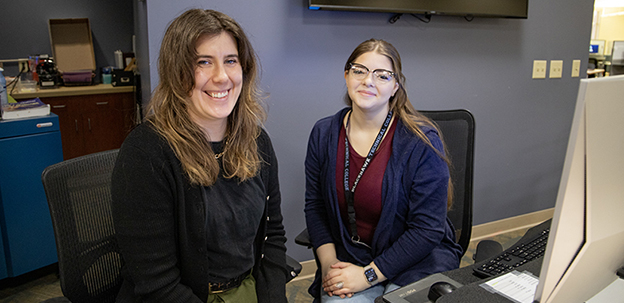 Student worker sitting with librarian